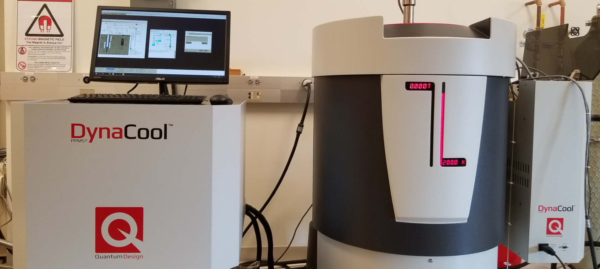 Laboratory equipment with a Dynacool system and a computer monitor displaying data.